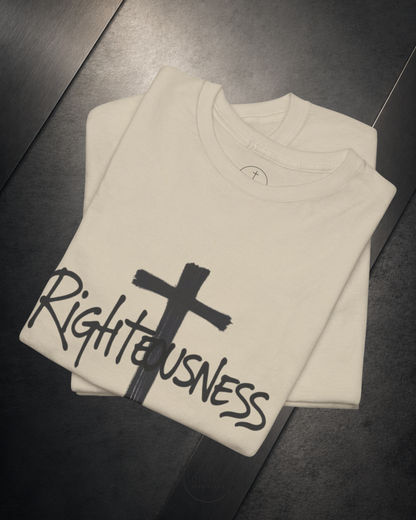 Folded beige sweatshirt with a black cross and 'Righteousness' text on a dark surface