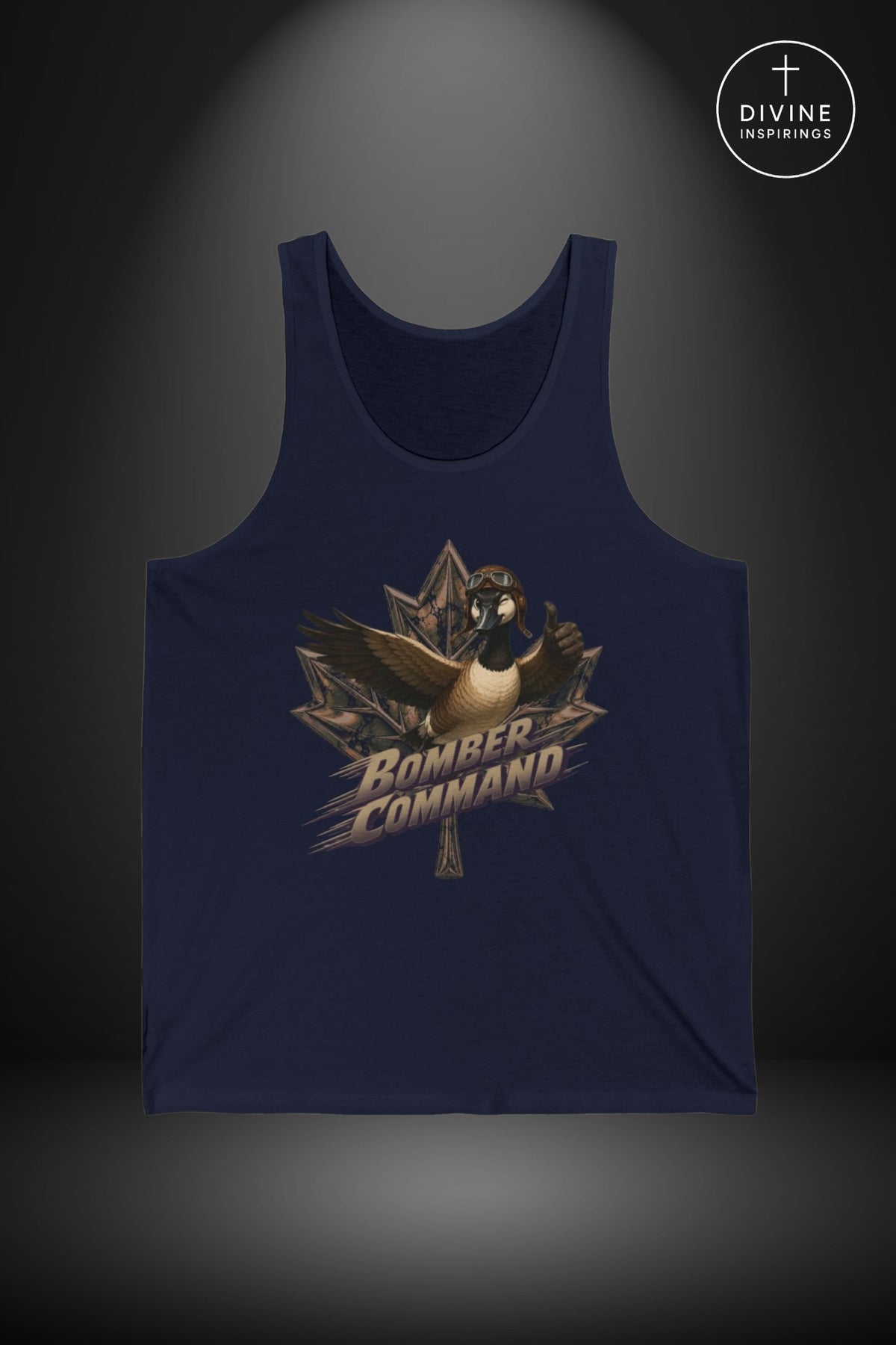 A navy blue tank top with a graphic print of a goose wearing a bomb defusal helmet and the words 'BOMBER COMMAND' over a maple leaf, displayed on a dark gray background with a spotlight effect. A circular 'DIVINE Inspirings' logo is in the top right corner.