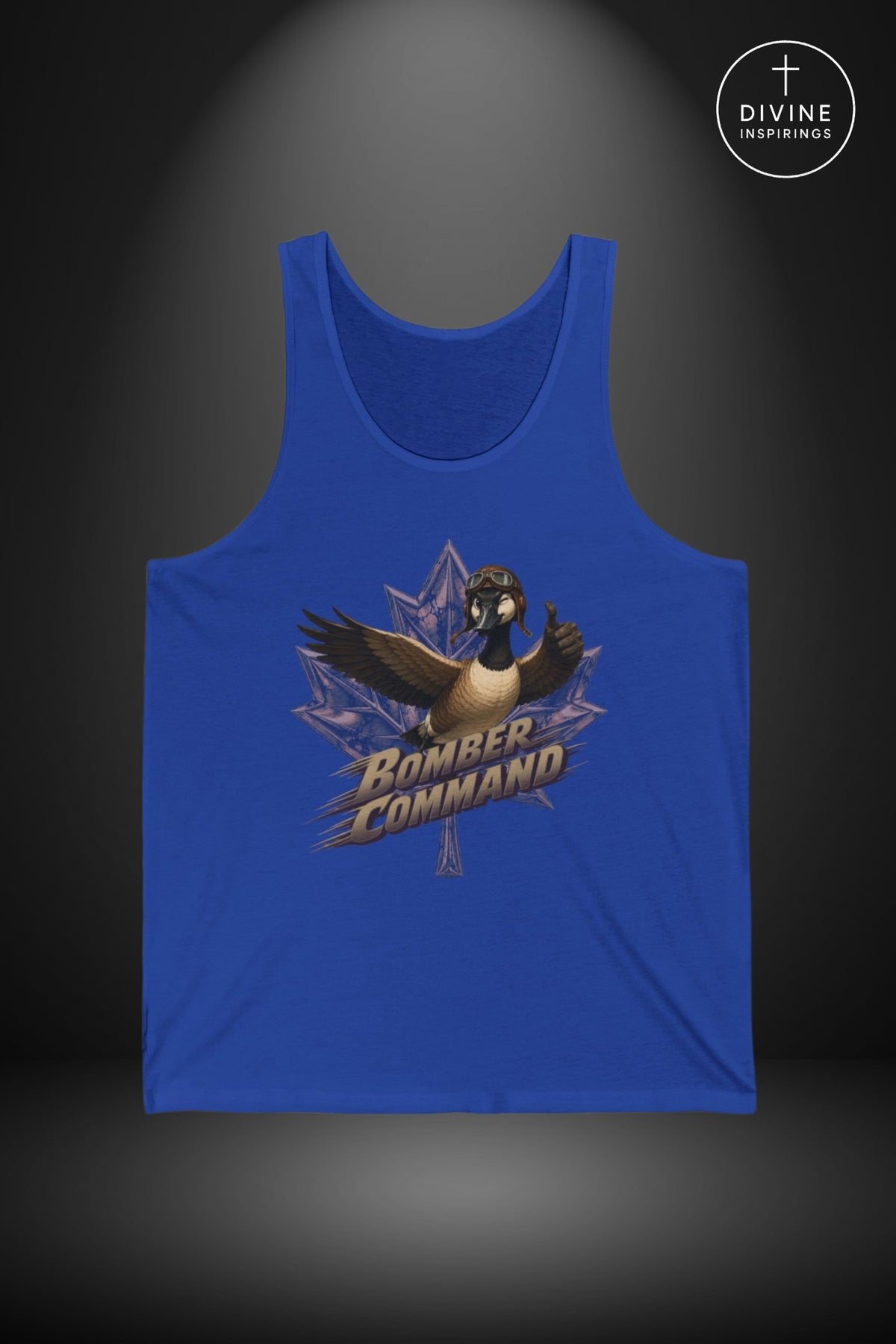 A royal blue tank top featuring a graphic of a Canada goose over a maple leaf with the words 'Bomber Command' in stylized lettering. The tank top is displayed against a dark gray background with a spotlight effect, and a circular 'Divine Inspirings' logo is visible in the top right corner.