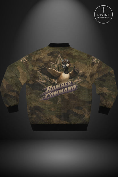 Back view of a bomber jacket featuring a green and brown camouflage pattern with a central graphic of a bird wearing a headset and the words 'BOMBER COMMAND' in stylized text. The jacket has black ribbed cuffs, hem, and collar, and is displayed against a dark gray background with a spotlight effect.