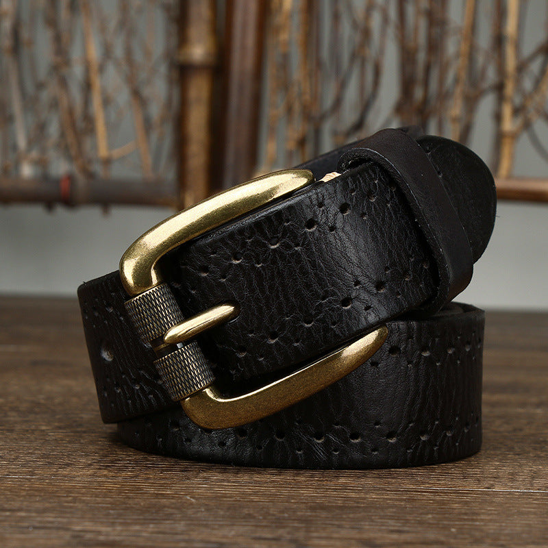Black leather belt with a gold buckle on a wooden surface.