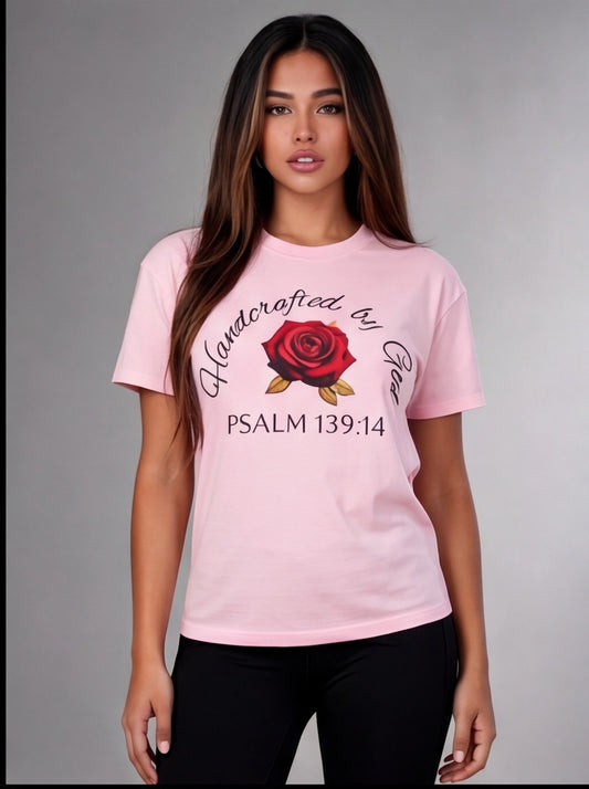 Woman wearing a pink t-shirt with a rose design and text on a gray background