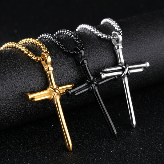 Three cross-shaped necklaces in gold, silver, and black on a dark background