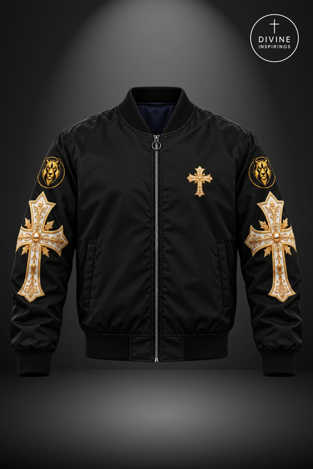 A black bomber jacket with ornate gold cross patches on both sleeves, a gold cross on the left chest, and a dark blue interior lining, shown against a dark gray gradient background with a Divine Inspirings logo in the top right.