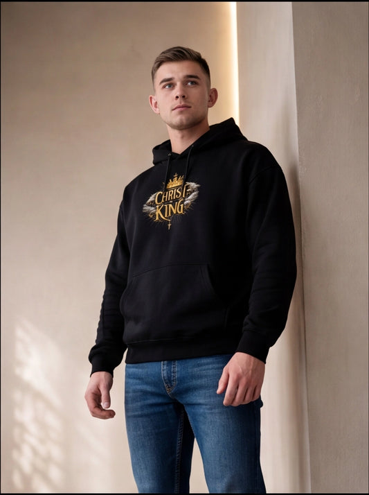 Man wearing a black hoodie with 'King of Christ' design against a neutral background