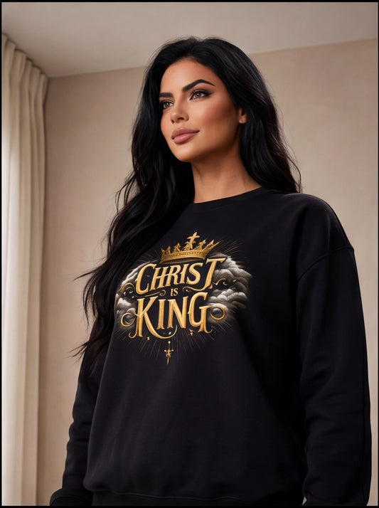 Woman wearing a black sweatshirt with 'Christ King' text and design.