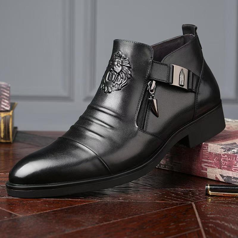 Black leather boot with lion emblem on a wooden surface