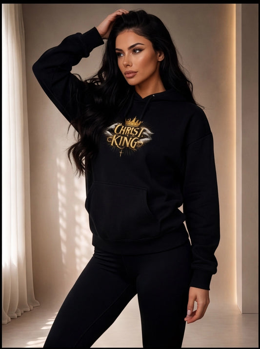 Woman wearing a black hoodie with 'King of Christ' text and crown graphic.