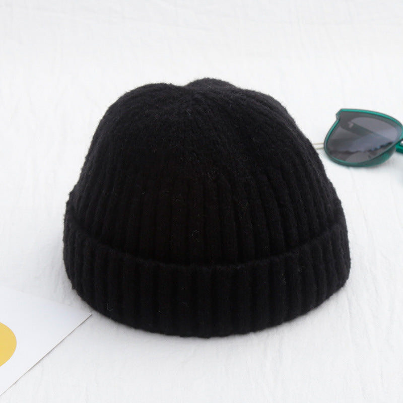 Black knit beanie on a white background