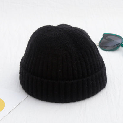 Black knit beanie on a white background
