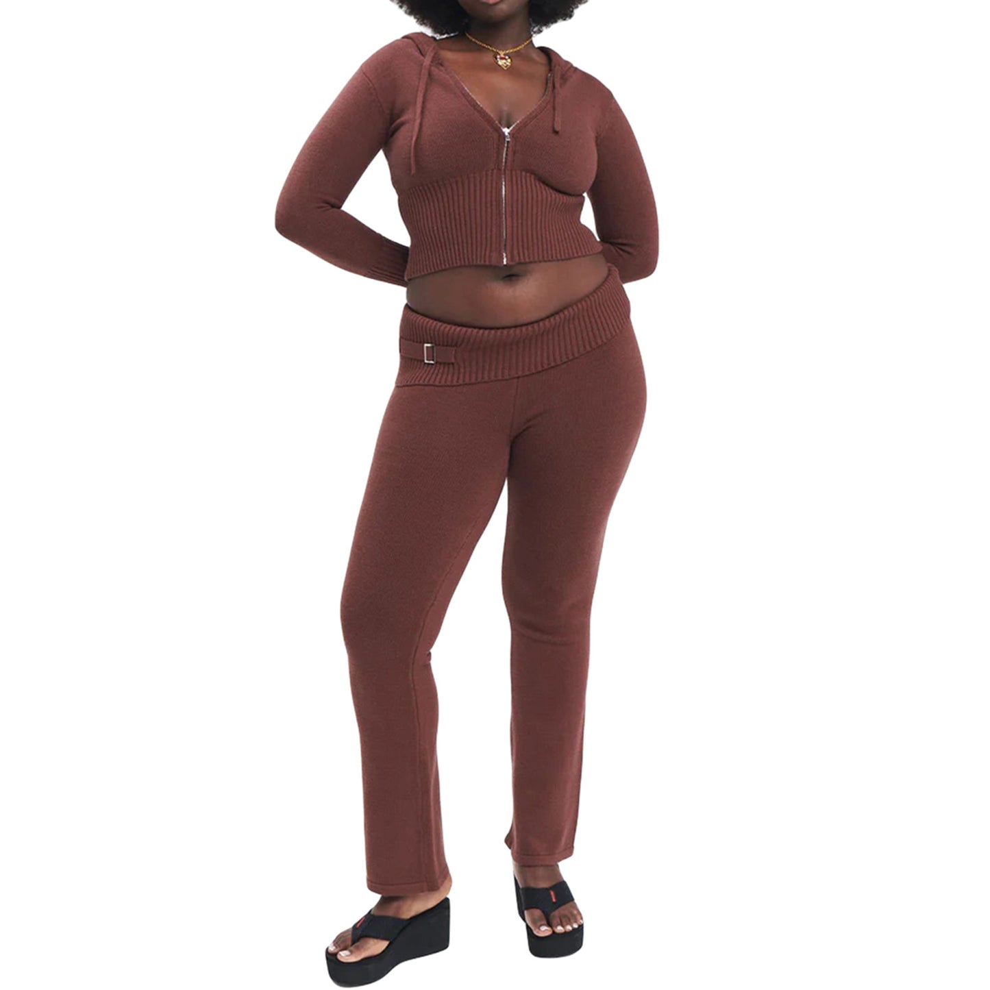 Woman wearing a brown knit outfit on a white background