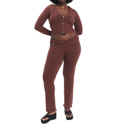 Woman wearing a brown knit outfit on a white background