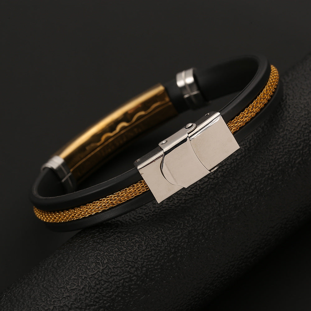 Bracelet with black strap, gold accents, and silver clasp on a dark background