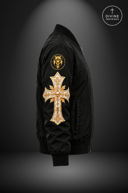 A black bomber jacket shown in side profile against a dark gray gradient background. The jacket features a large gold cross patch embellished with rhinestones on the right sleeve, a smaller gold lion emblem on the upper left sleeve, and a small white cross patch on the left chest.