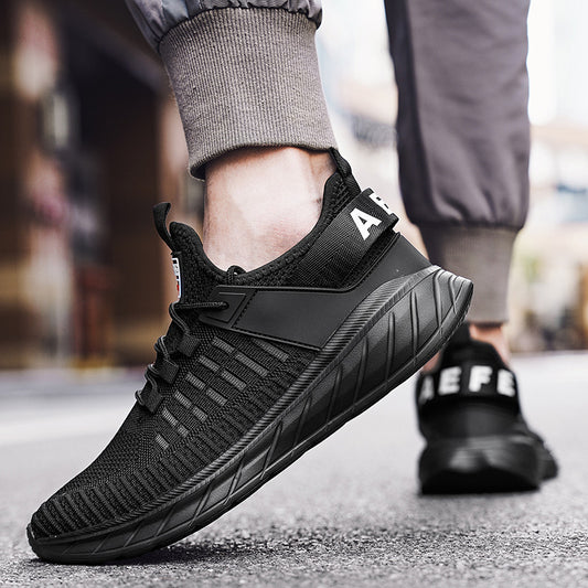 Black athletic shoe with brand logo on a blurred street background