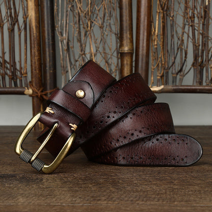 Brown leather belt with gold buckle on a wooden surface
