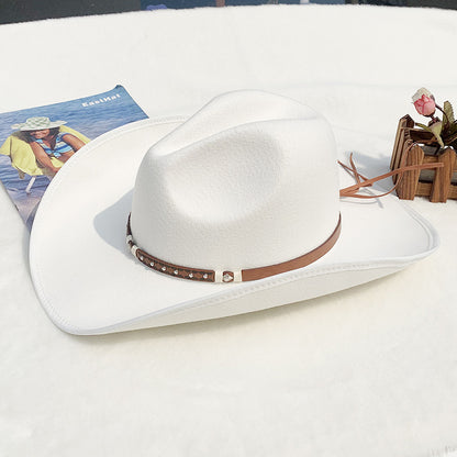 White cowboy hat with a brown band on a white surface