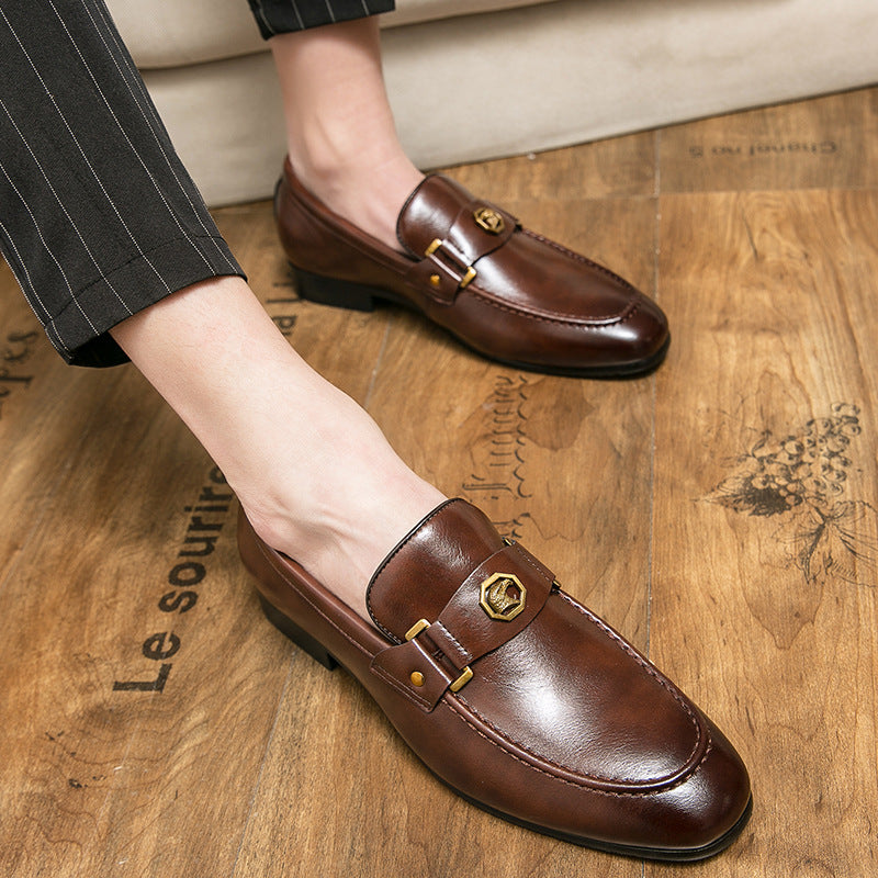 Brown leather loafers worn on a wooden floor