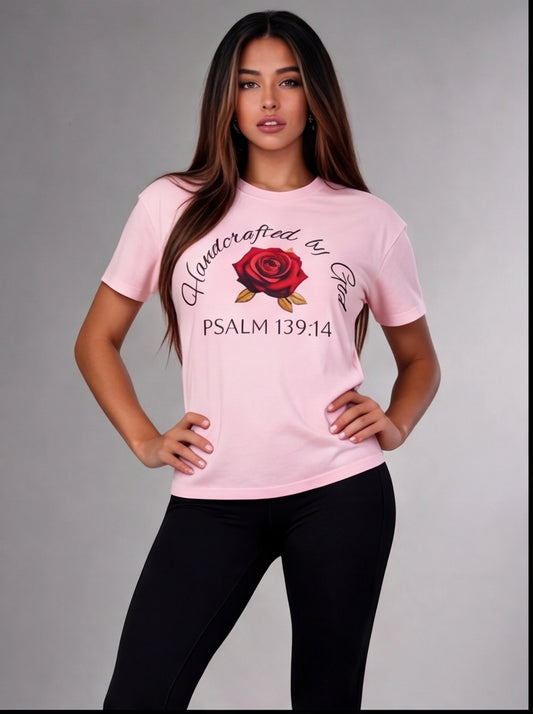 Woman wearing a pink t-shirt with a rose design and text on a gray background
