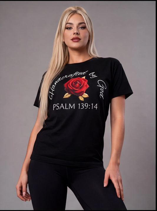 Woman wearing a black t-shirt with a red rose graphic and text on a gray background