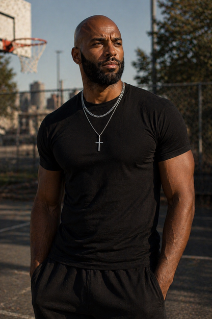 Man wearing a black t-shirt and shorts on a basketball court