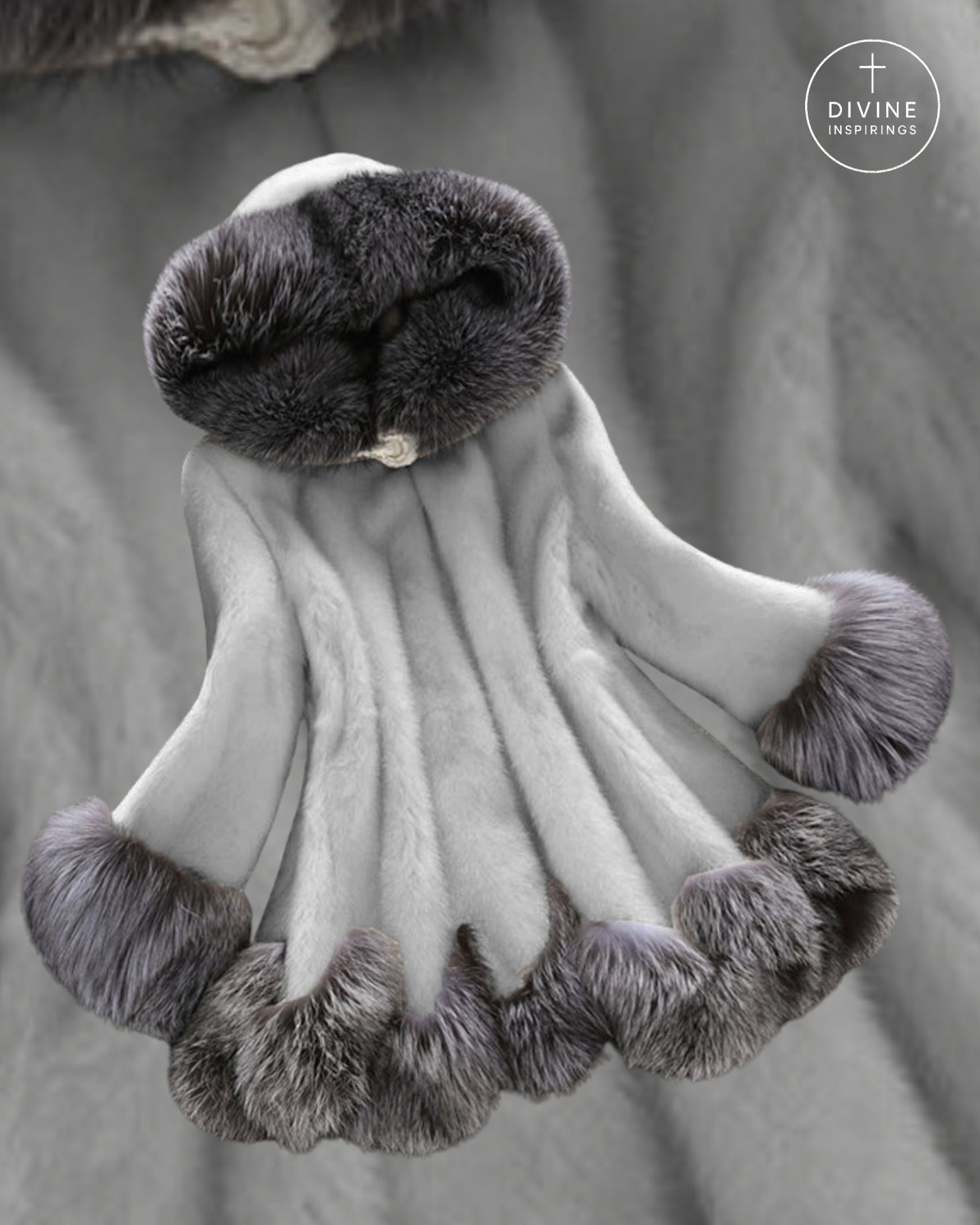 A light gray faux fur garment with dark gray and black fur trim, displayed against a matching gray fabric background. A circular 'DIVINE INSPIRINGS' logo is visible in the top right corner.