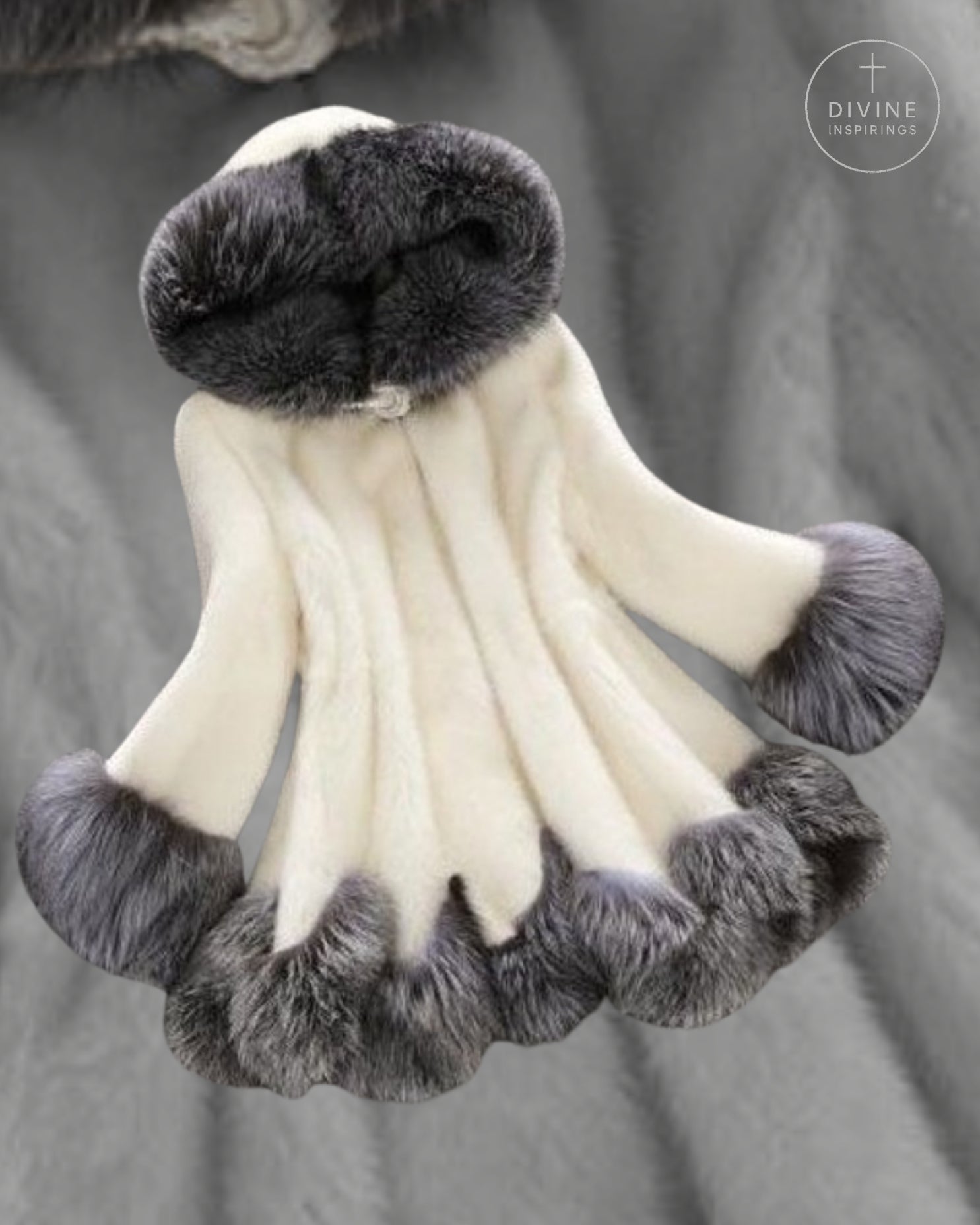 A cream-colored faux fur garment with dark gray faux fur trim, including a large collar and cuffs, displayed against a gray textured fabric background.