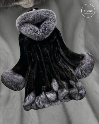A black fur-trimmed religious habit or cloak with gray fur trim on the collar, cuffs, and hem, shown against a gray fabric background. A circular 'DIVINE INSPIRATION' logo is visible in the top right corner.