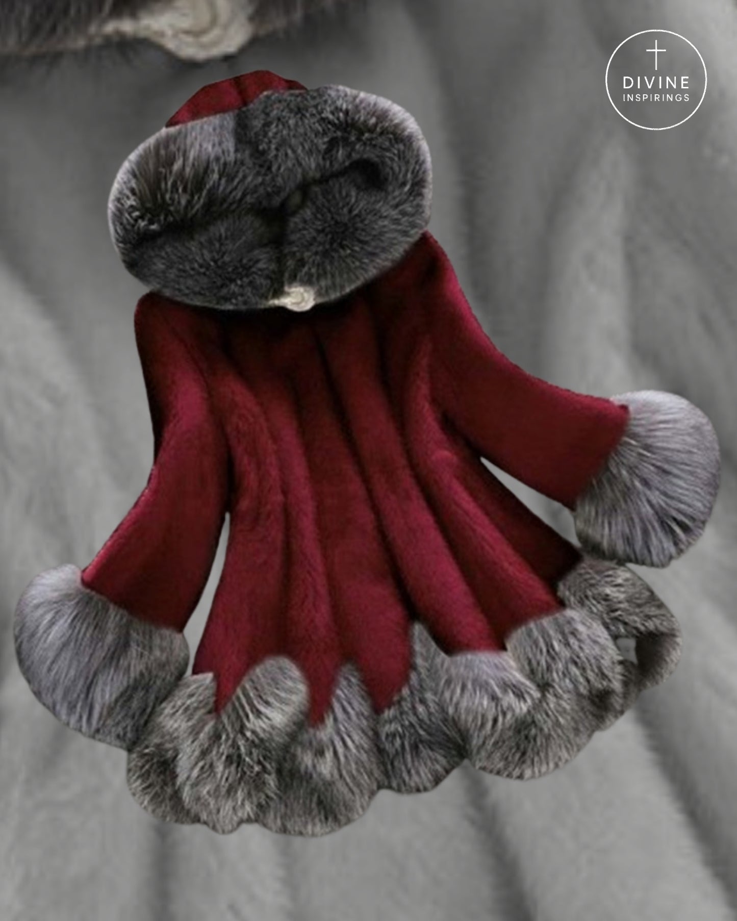 A plush red faux-fur hooded cloak or robe with gray faux-fur trim around the hood, cuffs, and hem, displayed against a gray fabric background. A circular 'DIVINE INSPIRINGS' logo is visible in the top right corner.