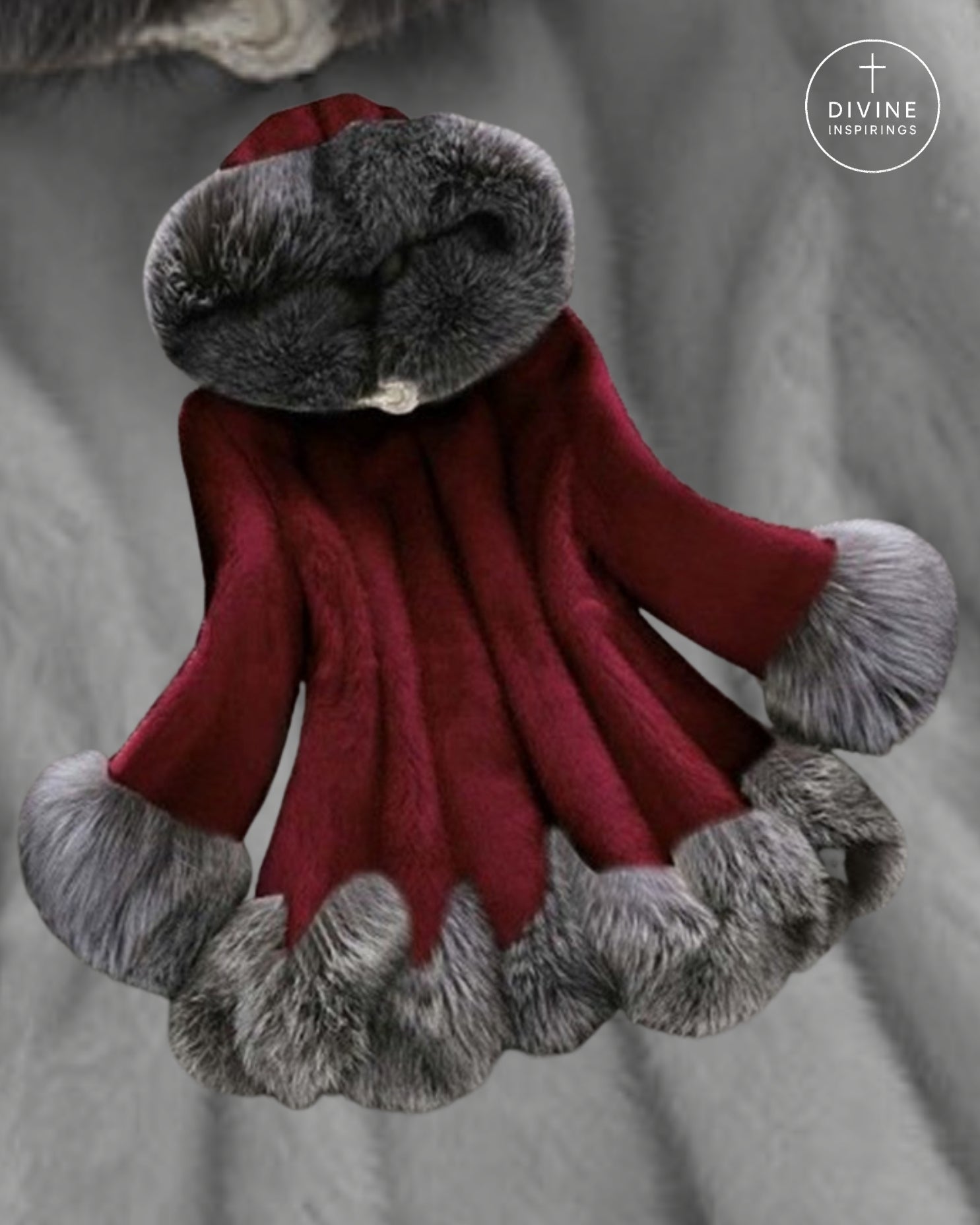 A plush red faux-fur hooded cloak or robe with gray faux-fur trim around the hood, cuffs, and hem, displayed against a gray fabric background. A circular 'DIVINE INSPIRINGS' logo is visible in the top right corner.