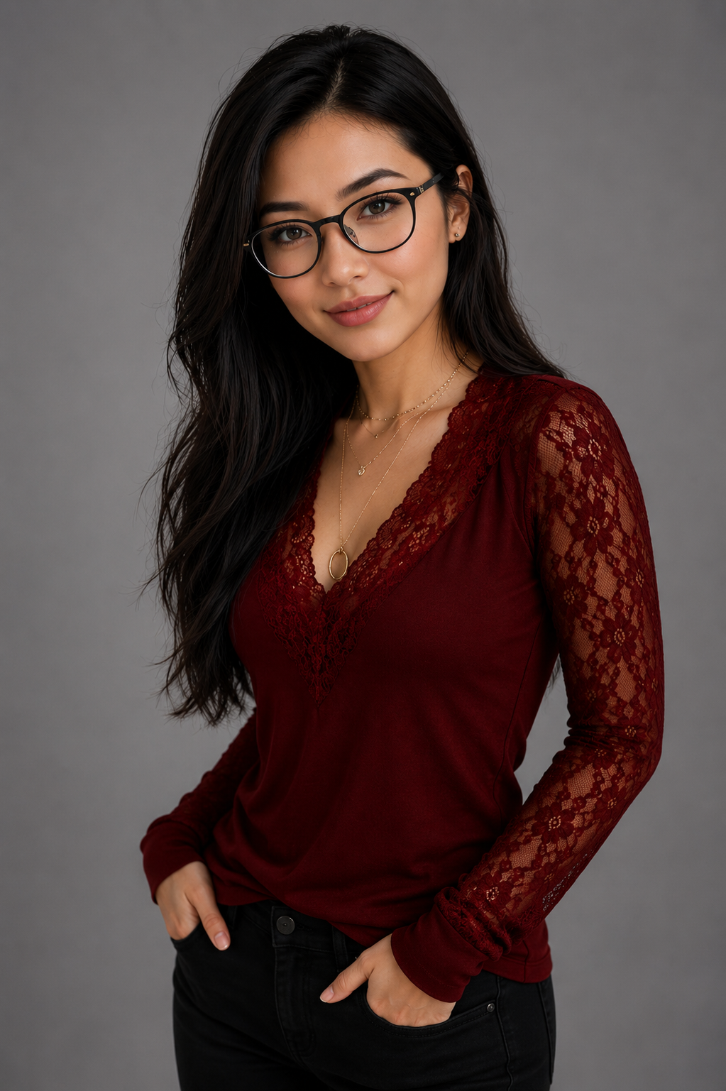 Woman wearing a burgundy lace top against a gray background