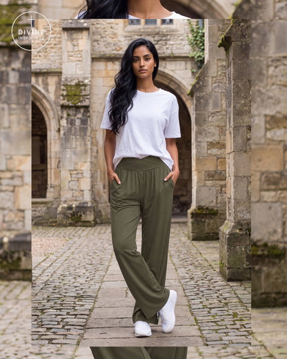 A woman stands in a stone courtyard wearing olive green wide-leg pants, a white t-shirt, and white sneakers. A circular 'Divine Inspirings' brand logo is visible in the top-left corner.