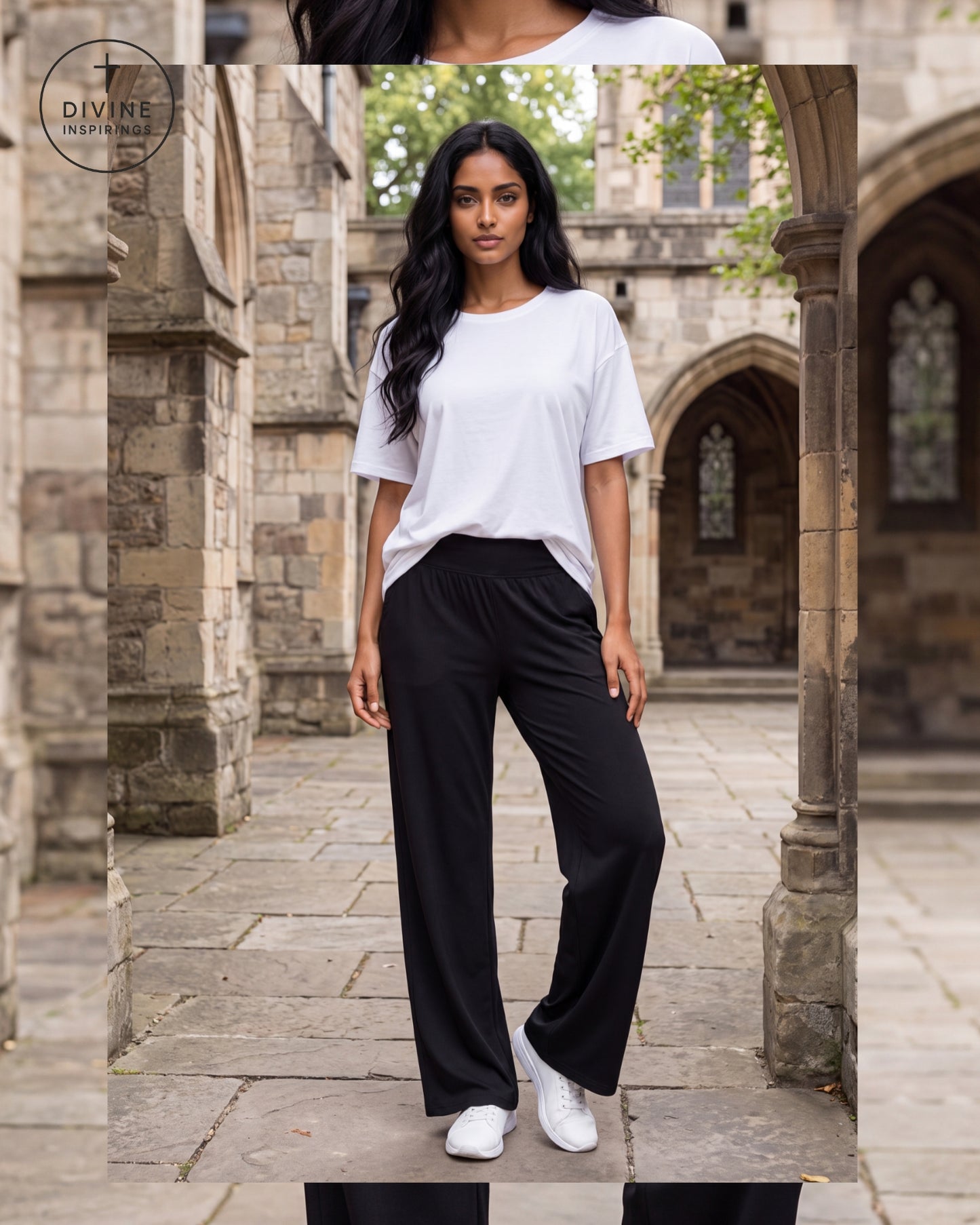 A woman stands in a stone courtyard wearing a loose white short-sleeve T-shirt, black wide-leg pants, and white sneakers. A circular 'Divine Inspirings' logo appears in the upper left.