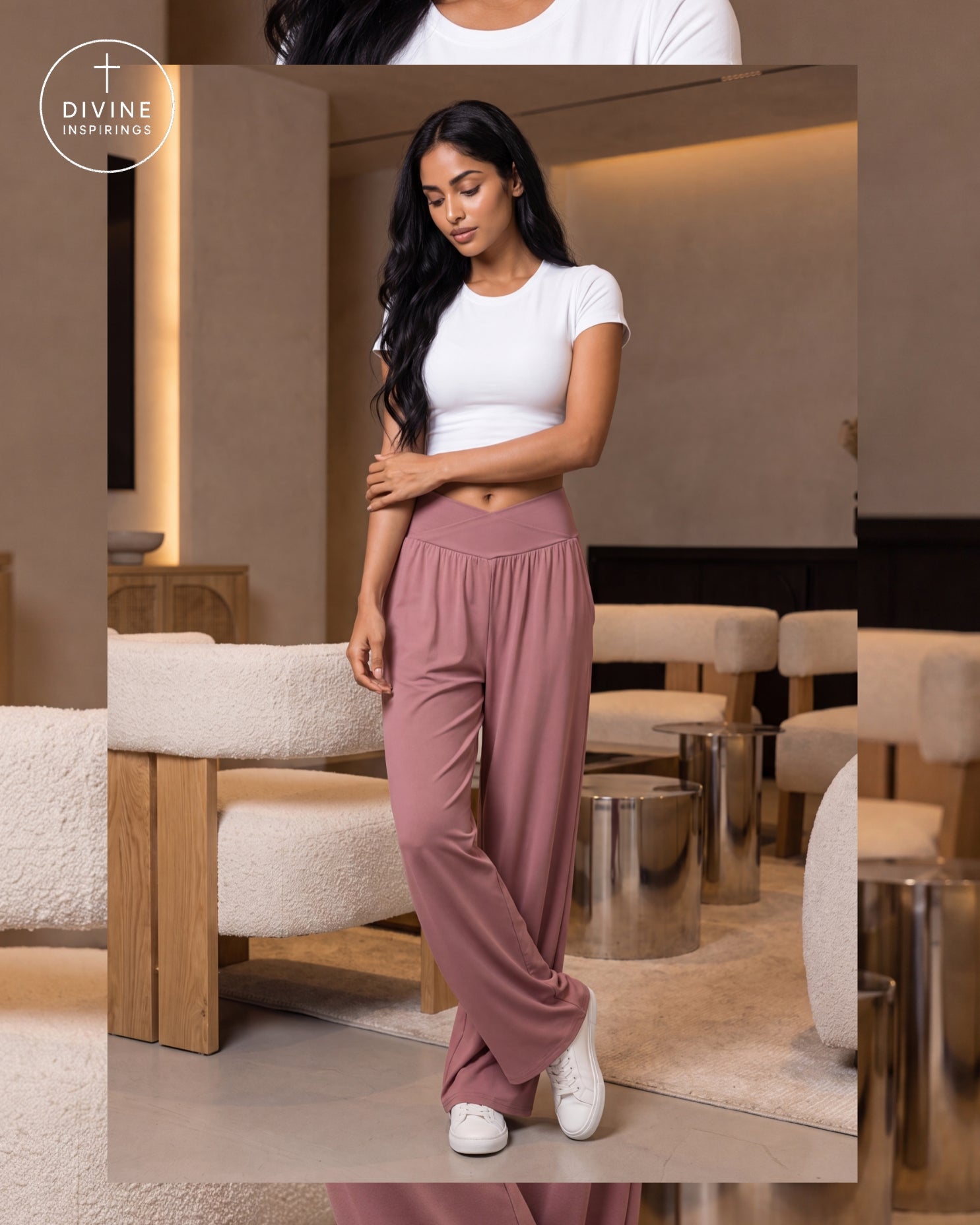 A woman models dusty rose wide-leg lounge pants with a matching elastic waistband, styled with a white crop top and white sneakers in a modern lounge setting. The Divine Inspirings logo is visible in the top left corner.