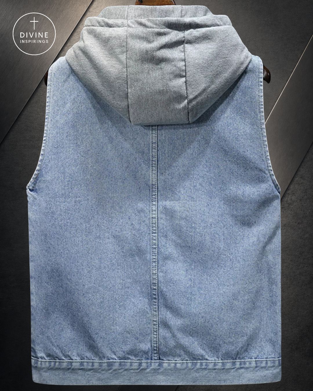 A light blue denim hooded vest shown from the back, featuring a central seam and a hood, displayed against a dark gray background with a DIVINE INSPIRINGS logo in the top left corner.