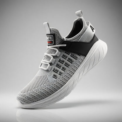 Gray athletic shoe with black accents on a gray background