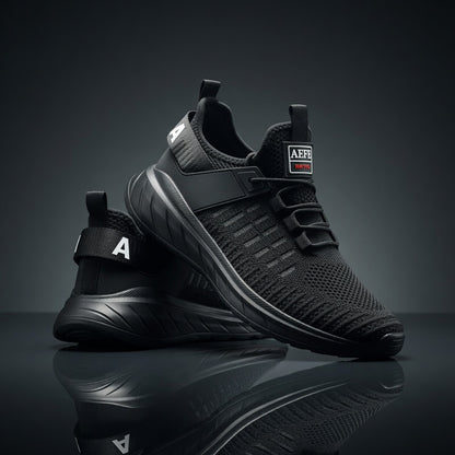 Black athletic shoes with brand logo on a reflective surface