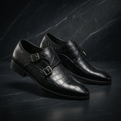 Pair of black crocodile-patterned dress shoes on a dark textured background