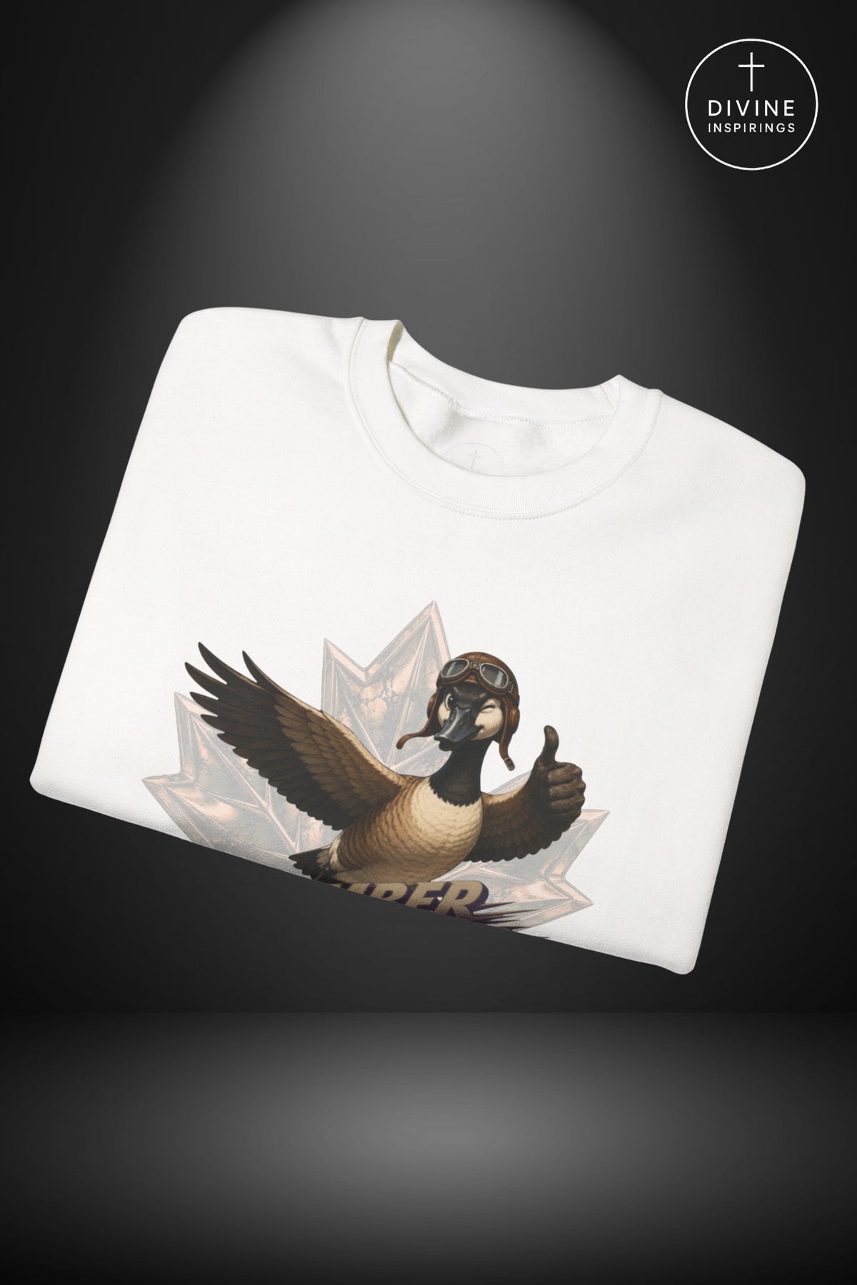 A folded white crewneck sweatshirt featuring a graphic of a geese with wings spread, set against a dark gray background with a spotlight effect and a 'Divine Inspirings' logo in the top right corner.