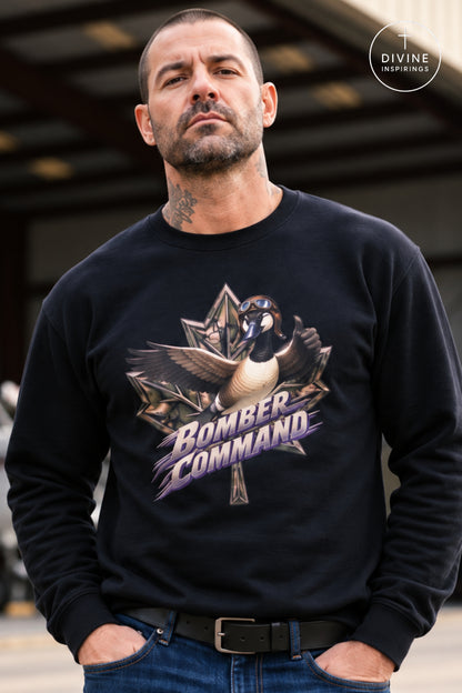 A man wearing a black crewneck sweatshirt with a graphic of a goose and the words 'Bomber Command' in purple and gold. The background is a blurred industrial setting.