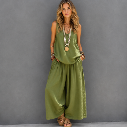Woman wearing a green jumpsuit against a gray background