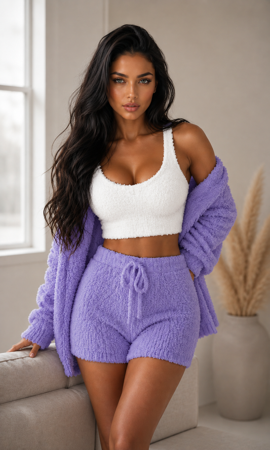 Woman wearing a purple knit set with a white top in a room.