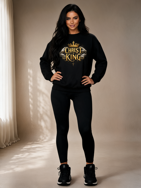 Woman wearing a black sweatshirt with 'Christ King' text in gold, standing against a neutral background.