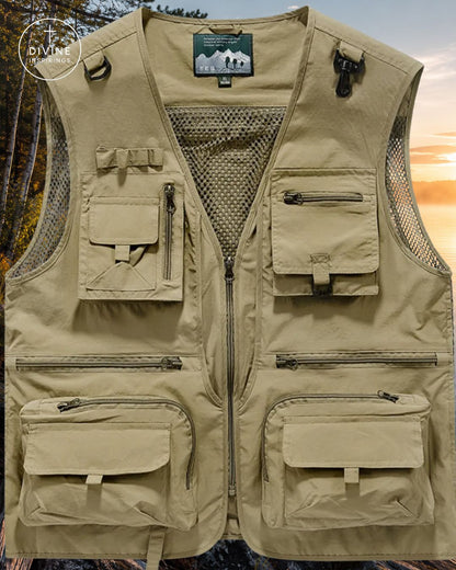 A tan utility fishing vest with multiple zippered and flap pockets, shown against a scenic forest sunset background. The brand label on the inner collar reads 'Divergent'.