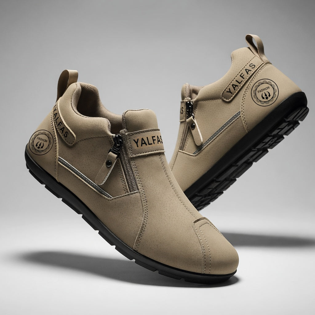 Beige ankle boots with zippers on a gray background