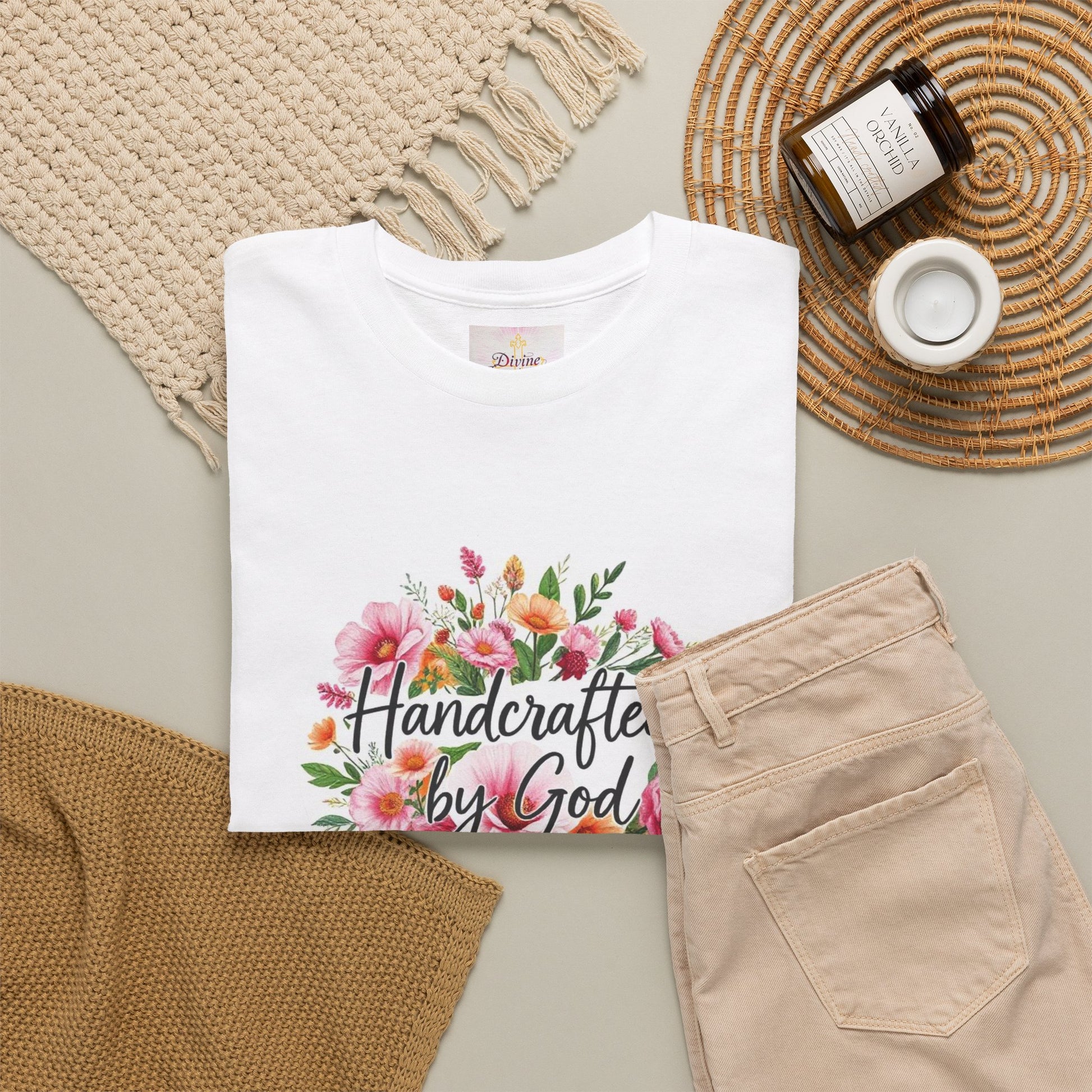 Folded White womans tee with 'Handcrafted by God' in a floral arrangement print