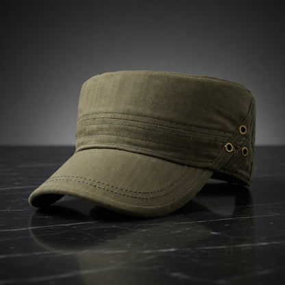 Green military-style cap on a dark surface with a gray background