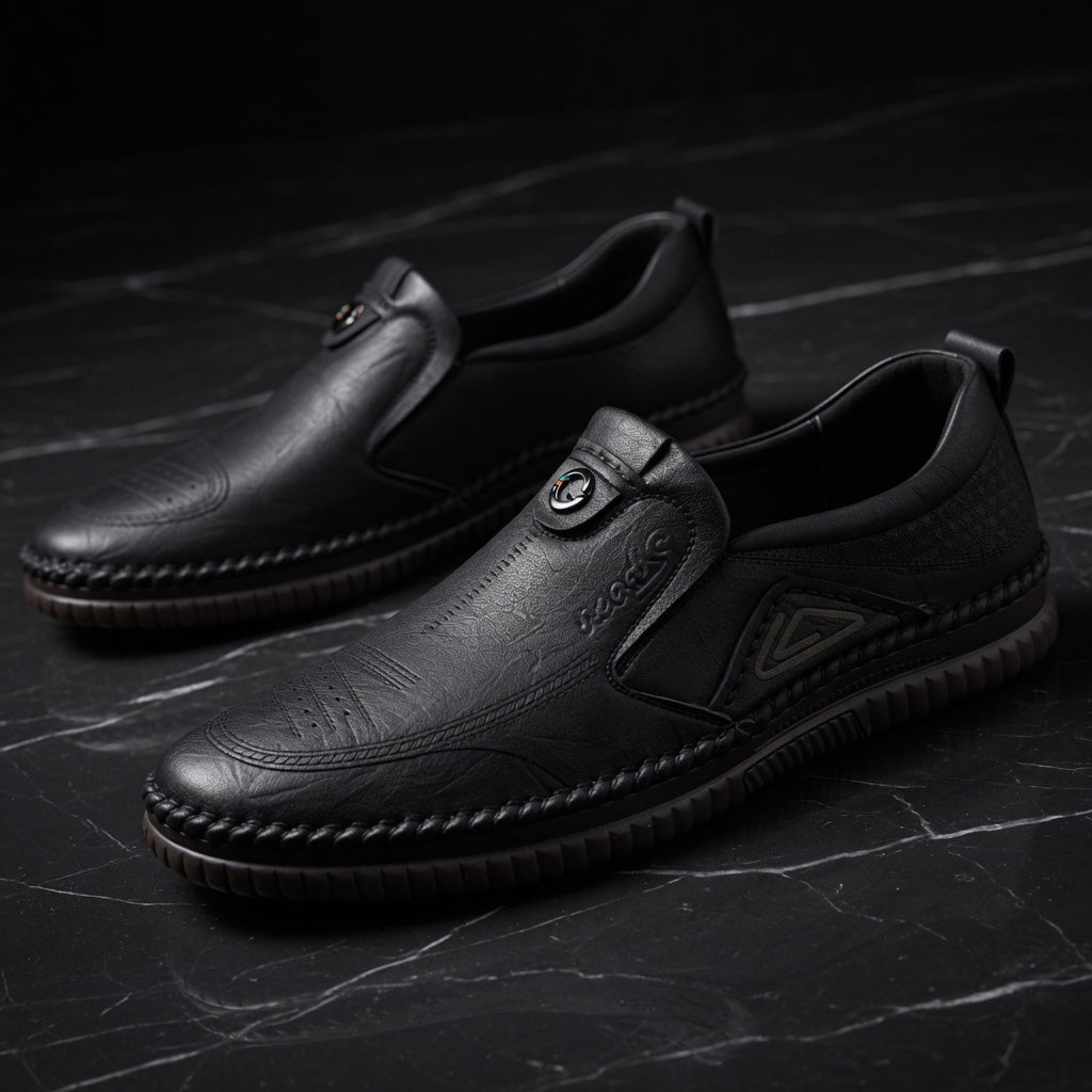 Pair of black leather shoes on a dark textured surface