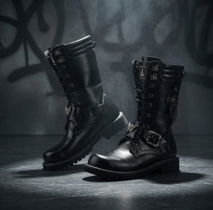 Pair of black leather boots with metal accents on a dark background