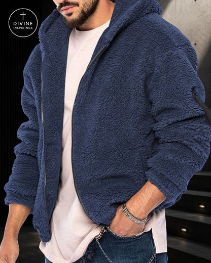 A man wearing a navy blue sherpa fleece zip-up hoodie over a white t-shirt and jeans, with a DIVINE INSPIRINGS logo in the top-left corner.